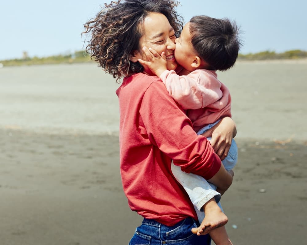 Getty Images 1419576903 Mother boy frolic beach